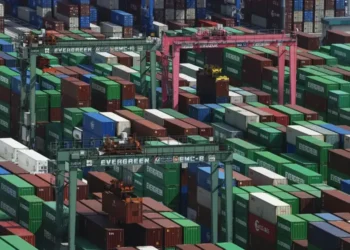 Shipping containers stacked at a Japanese port during export growth - Michi Ono/Kyodo News via AP