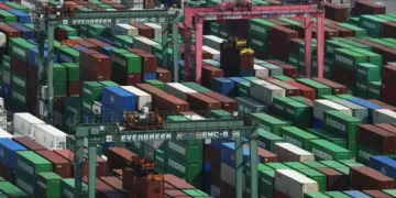 Shipping containers stacked at a Japanese port during export growth - Michi Ono/Kyodo News via AP