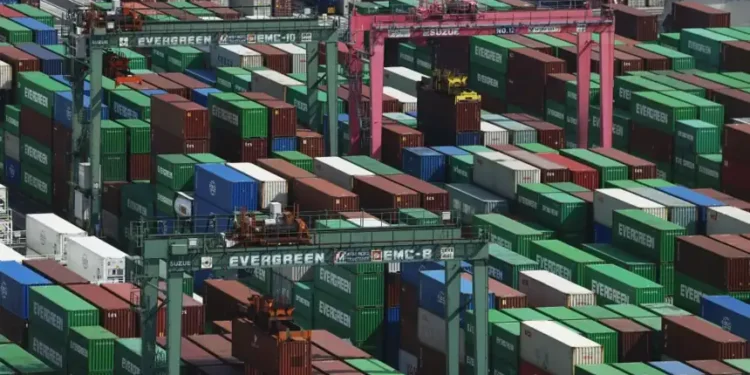 Shipping containers stacked at a Japanese port during export growth - Michi Ono/Kyodo News via AP
