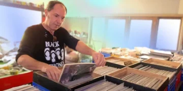 Jon Ordon surrounded by thousands of vinyl records in storage - Credit: Headphonesty