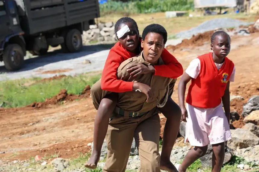 Emergency responders outside burned girls school dormitory in Kenya - AP Photo/Andrew Kasuku
