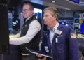 Traders react as Micron stock rally lifts Wall Street indexes - AP Photo/Richard Drew