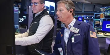 Traders react as Micron stock rally lifts Wall Street indexes - AP Photo/Richard Drew