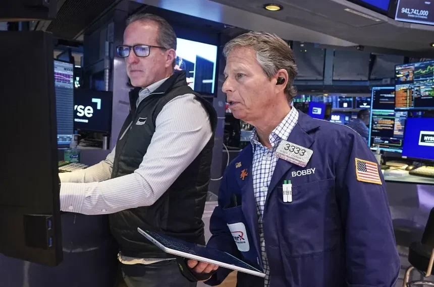 Traders react as Micron stock rally lifts Wall Street indexes - AP Photo/Richard Drew