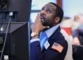 Traders monitor U.S. stock markets as oil prices fluctuate sharply - AP Photo/Richard Drew