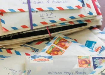 Handwritten letters and envelopes displayed beside vintage stationery materials - AP Photo/Holly Ramer