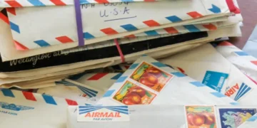 Handwritten letters and envelopes displayed beside vintage stationery materials - AP Photo/Holly Ramer