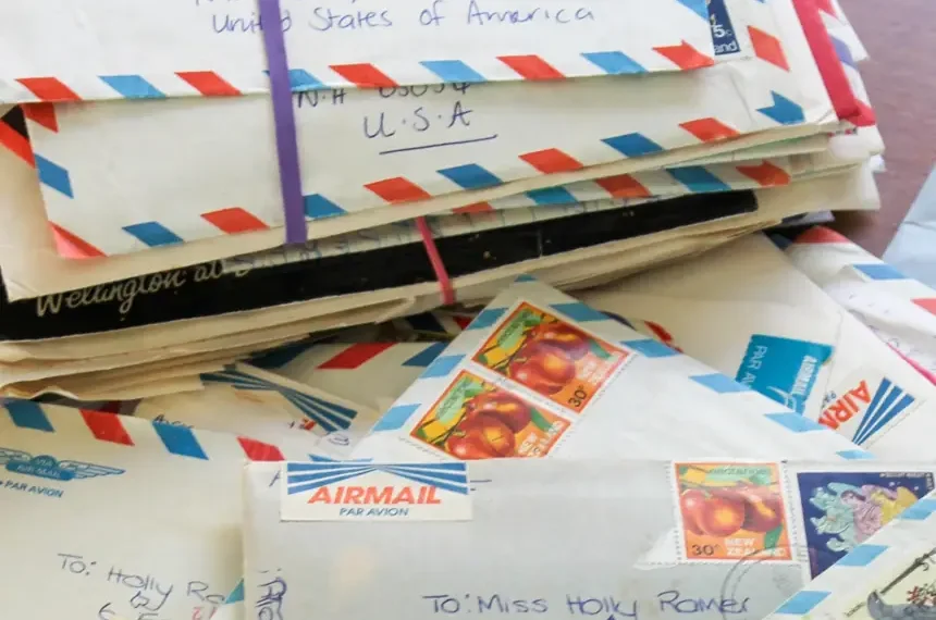 Handwritten letters and envelopes displayed beside vintage stationery materials - AP Photo/Holly Ramer