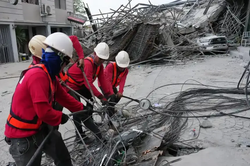 Rescue workers search through rubble after hotel collapse in Pampanga - AP Photo/Aaron Favila