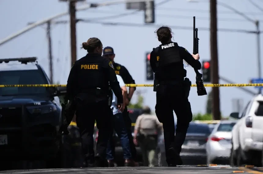 Police respond outside the Islamic Center of San Diego after a deadly shooting- AP Photo/Gregory Bull