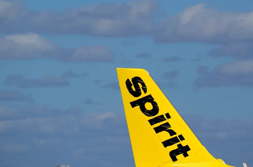 Donald Trump speaking as Spirit Airlines aircraft sits on runway - AP Photo/wilfredo Lee, File