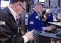 Traders monitor U.S. stock market gains as oil prices decline - AP Photo/Richard Drew