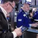 Traders monitor U.S. stock market gains as oil prices decline - AP Photo/Richard Drew