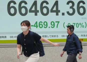 Electronic stock board displays Asian market declines amid geopolitical tensions - AP Photo/Eugene Hoshiko