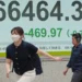 Electronic stock board displays Asian market declines amid geopolitical tensions - AP Photo/Eugene Hoshiko