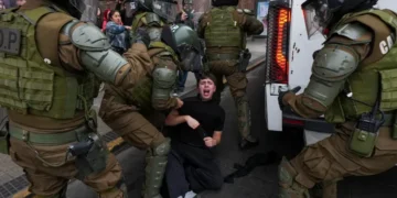 Protesters and police clash during education cuts rally in Santiago - AP Photo/Esteban Felix
