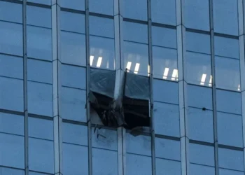 Damaged facade of Beijing skyscraper after light aircraft collision - AP Photo/Han Guan Ng