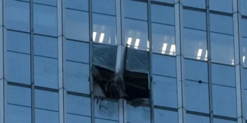 Damaged facade of Beijing skyscraper after light aircraft collision - AP Photo/Han Guan Ng