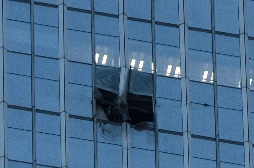 Damaged facade of Beijing skyscraper after light aircraft collision - AP Photo/Han Guan Ng
