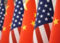 Chinese and American flags amid escalating trade and defense tensions - AP Photo/Mark Schiefelbein, File