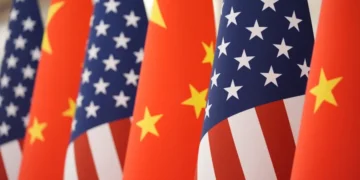 Chinese and American flags amid escalating trade and defense tensions - AP Photo/Mark Schiefelbein, File