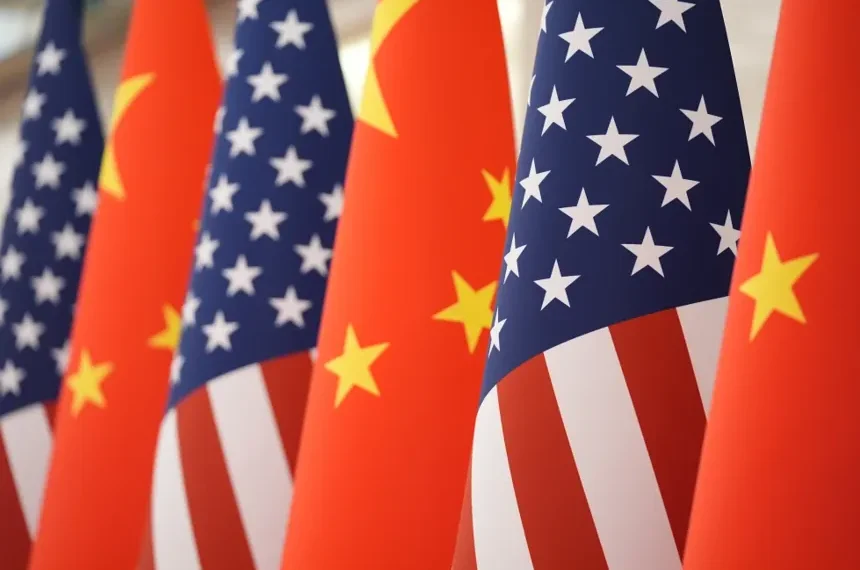 Chinese and American flags amid escalating trade and defense tensions - AP Photo/Mark Schiefelbein, File