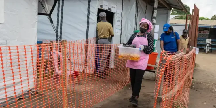 Volunteers prepare meals for Ebola patients in Bunia - AP Photo/Moses Sawasawa