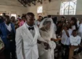 Newlyweds celebrate under Ebola restrictions in eastern Congo - AP Photo/Moses Sawasawa