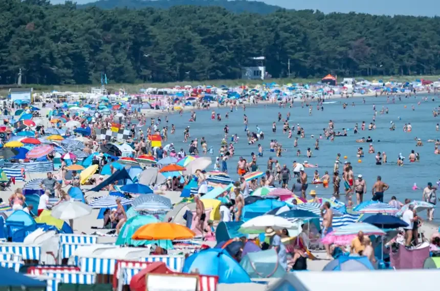 People seek shade during record-breaking heat across European cities - Stefan Sauer/dpa via AP
