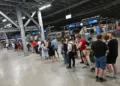 Passengers waiting during Germany rail network disruption at station - Peter Kneffel/dpa via AP