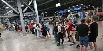 Passengers waiting during Germany rail network disruption at station - Peter Kneffel/dpa via AP