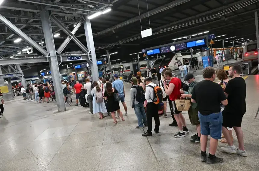Passengers waiting during Germany rail network disruption at station - Peter Kneffel/dpa via AP