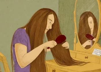 Woman brushing long hair as part of daily care - BBC/ Prashanti Aswani