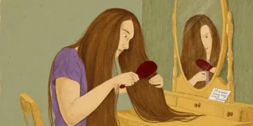 Woman brushing long hair as part of daily care - BBC/ Prashanti Aswani