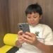 Malaysian family reacts to new social media age restrictionsHew Chee Weng, 11, uses smartphone in Kuala Lumpur, Malaysia, Monday, June 1, 2026 - AP Photo/Syawalludin Zain