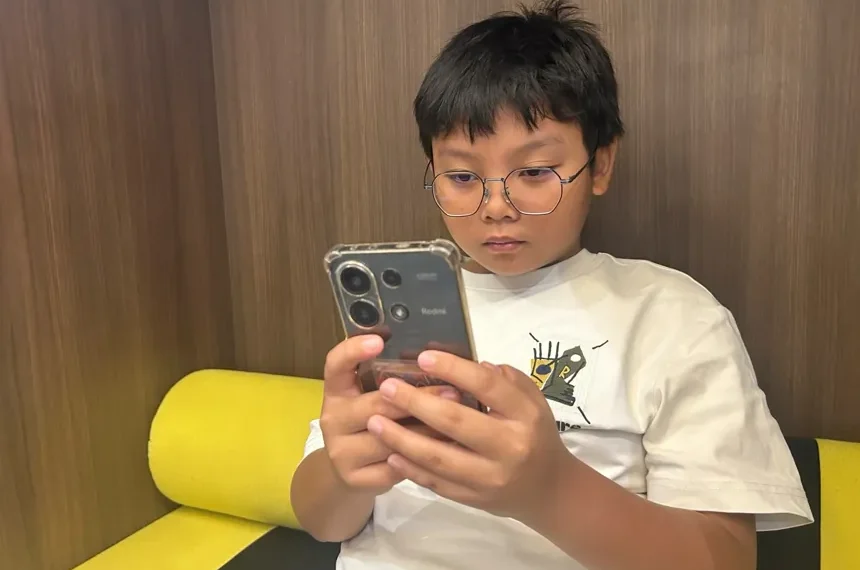 Malaysian family reacts to new social media age restrictionsHew Chee Weng, 11, uses smartphone in Kuala Lumpur, Malaysia, Monday, June 1, 2026 - AP Photo/Syawalludin Zain