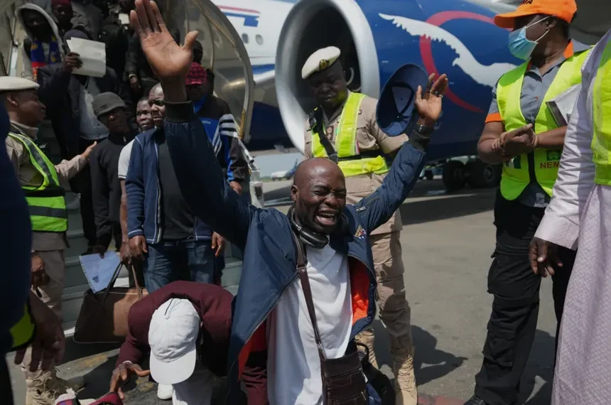 Nigerian migrants arrive home after returning from South Africa - AP Photo/Sunday Alamba
