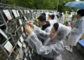 Korean adoptees place name tags at memorial wall in Paju - AP Photo/Ahn Young-joon