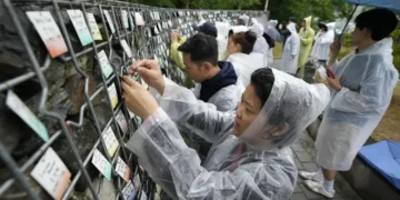Korean adoptees place name tags at memorial wall in Paju - AP Photo/Ahn Young-joon