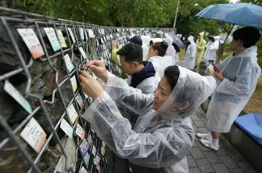 Korean adoptees place name tags at memorial wall in Paju - AP Photo/Ahn Young-joon