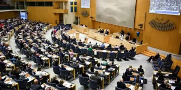 Swedish parliament debates new migrant reporting legislation - Fredrik Sandberg/TT News Agency via AP