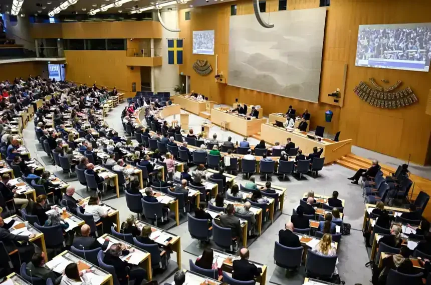 Swedish parliament debates new migrant reporting legislation - Fredrik Sandberg/TT News Agency via AP