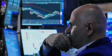 Traders monitor rising U.S. stock indexes during Wall Street trading session. - AP Photo/Richard Drew