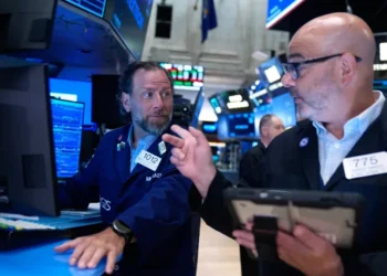Traders monitor falling AI technology stocks on Wall Street trading screens. - AP Photo/Seth Wenig