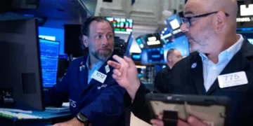Traders monitor falling AI technology stocks on Wall Street trading screens. - AP Photo/Seth Wenig