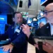 Traders monitor falling AI technology stocks on Wall Street trading screens. - AP Photo/Seth Wenig