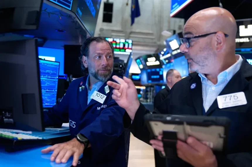 Traders monitor falling AI technology stocks on Wall Street trading screens. - AP Photo/Seth Wenig