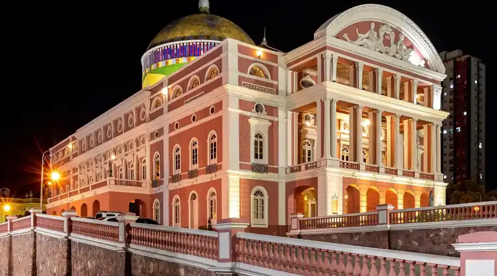 Exterior view of the historic Amazon Theatre in Manaus, Amazonas, Brazil, illuminated at night.