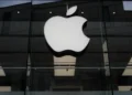 Apple and OpenAI logos representing trade secrets lawsuit over AI hardware - AP Photo/Matthias Schrader, File