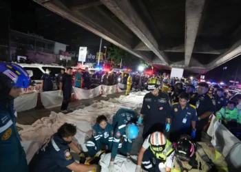 Emergency responders work at the scene of a deadly pub fire in Bangkok. - AP Photo/Sakchai Lalit